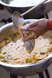 Midsection of person preparing food in bowl