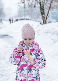 Portrait of girl standing on snow