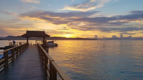 Pier on sea during sunset