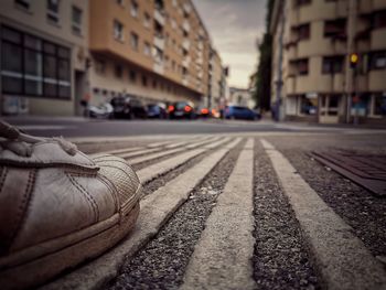 Surface level of railroad tracks with buildings in background