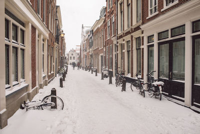 Street amidst buildings in city during winter