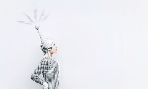 Portrait of woman standing against white background