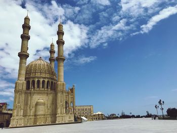 Low angle view of mosque against blue sky