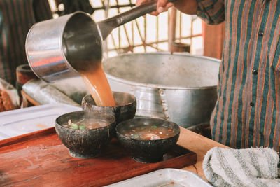 Close-up of person preparing food on table