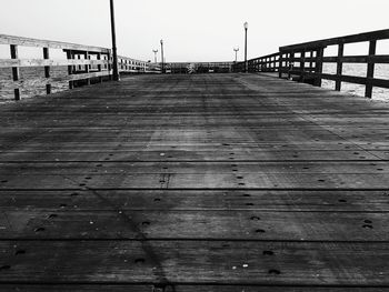 Low angle view of wooden pier against clear sky