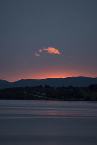 Scenic view of silhouette mountains against romantic sky at sunset