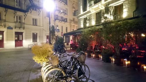 Street amidst buildings in city at night