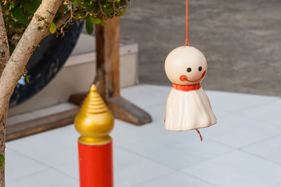 Chasing rain japanese doll hanging under tree on nature backgroud.