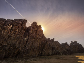 Rock formations against sky during sunset