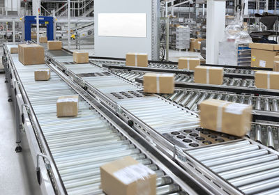 Automated warehouse. boxes with spare parts moving on conveyer