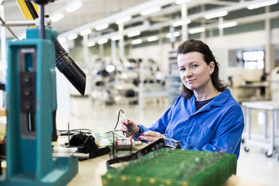 Portrait of woman working in factory