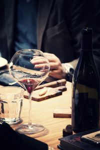 Close-up of man drinking glasses on table