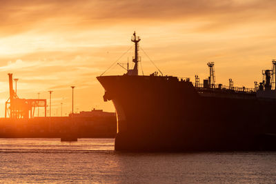 Profile of a tanker ship at sunset
