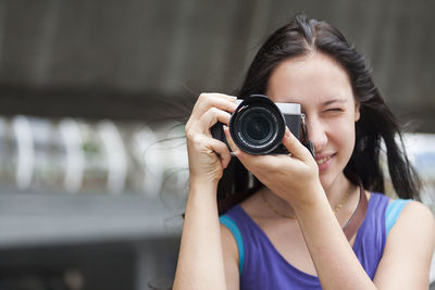 Close-up of woman photographing with camera