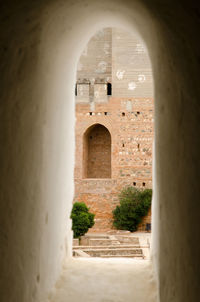 View of historic building seen through arch window