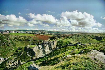 Panoramic shot of countryside landscape against cloudy sky