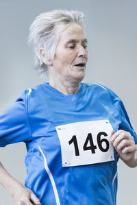 Close-up of senior athlete jogging outdoors