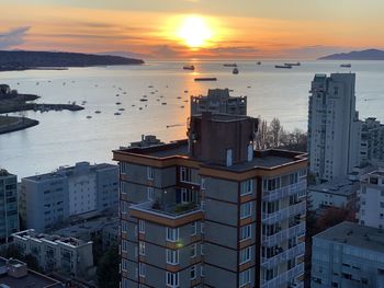 High angle view of buildings by sea against sky during sunset in vancouver 