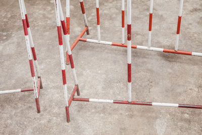 Red and white metal barrier on a street.