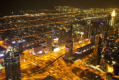 High angle view of illuminated buildings in city at night