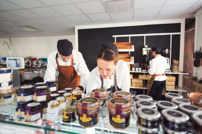 Male and female owners working in grocery store