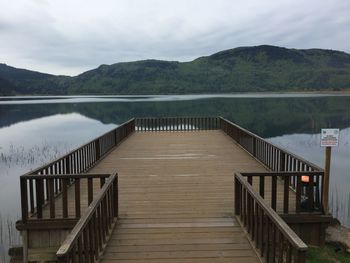 Pier over lake against sky