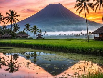 Scenic view of lake and mountains against sky during sunset