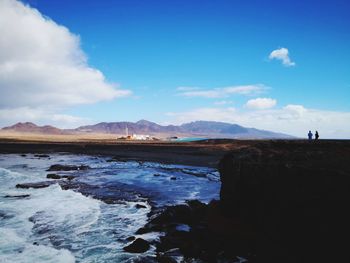 Scenic view of mountains against blue sky
