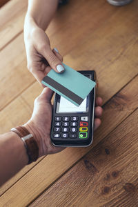 Woman paying through credit card in restaurant