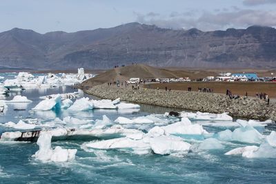 Scenic view of frozen lake against mountain range