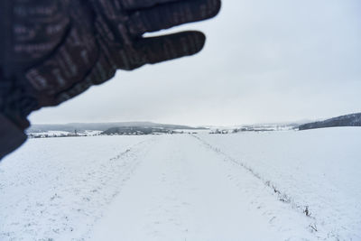 Scenic view of snow covered land against sky