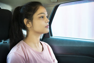 Young woman sitting in car