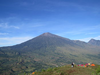 Scenic view of mountains against blue sky