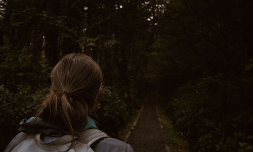 Rear view of woman against trees