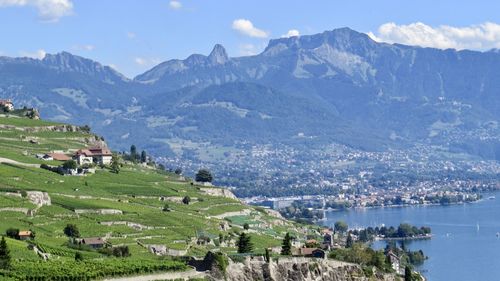 Panoramic view of townscape and mountains against sky