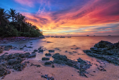 Scenic view of beach against sky during sunset