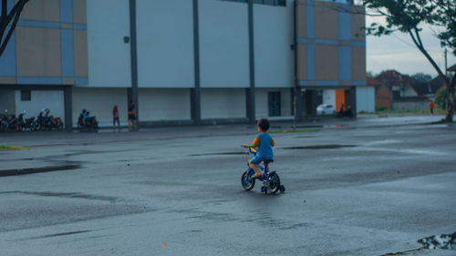 Man riding bicycle on street in city