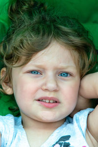 Close-up portrait of cute girl with blue eyes