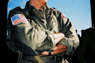 Midsection of soldier in uniform with arms crossed