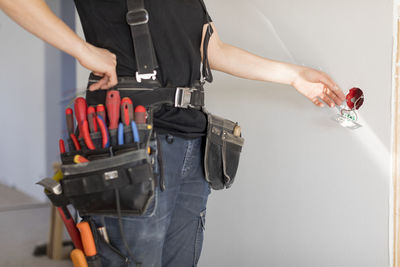 Female electrician renovating house