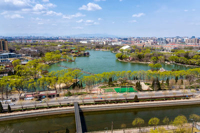 High angle view of river amidst buildings in city against sky