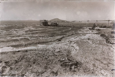 Scenic view of beach by sea against sky