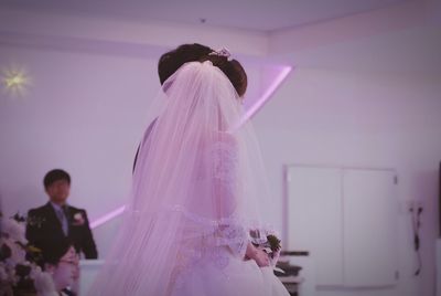 Side view of bride walking in wedding ceremony