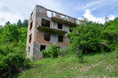 Low angle view of abandoned building against sky