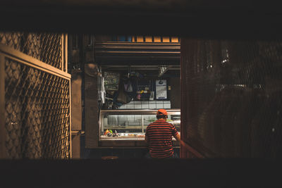 Rear view of people working in room