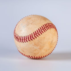 Close-up of baseball on white background