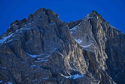 Scenic view of snowcapped mountains against clear blue sky