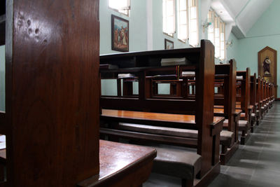 Empty bench by building