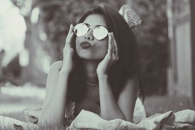 Young woman wearing sunglasses at park