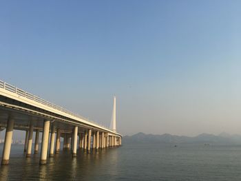 View of bridge over sea against clear sky